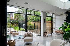 a living room filled with furniture and lots of windows