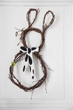 a piece of art made out of branches with a cow's head on it