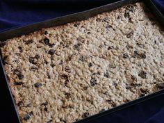 a pan filled with oatmeal and raisins on a blue cloth