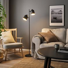 a living room scene with focus on the floor lamp and chair next to the couch