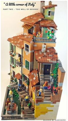 a lego model of a house with people on the roof and stairs leading up to it