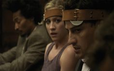 two people sitting next to each other with blindfolds on their heads and one person looking at the camera