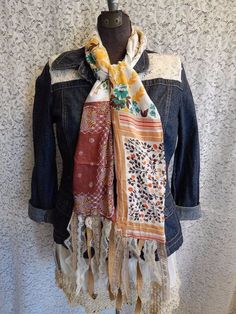 a denim jacket and scarf hanging on a mannequin's headdress