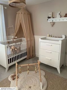 a baby's room with a crib, dresser and changing table in it