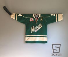 an old hockey jersey hanging on the wall