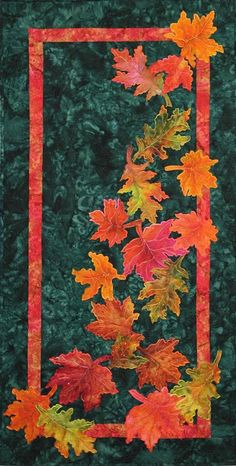 a quilted wall hanging with autumn leaves on it