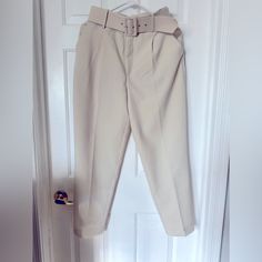 Elevate Your Wardrobe With These Stylish High-Waisted Pants From Zara. Perfect For Any Occasion, These Pants Feature A Solid Pattern And A Cream Color That Complements Any Outfit. The Pants Are Made Of Polyester Material And Have A Pleated Front Type, A Classic Fit, And A Straight Leg Style. The Pants Come With A Fabric-Covered Belt That Adds An Extra Touch Of Elegance To The Outfit. The Belted Feature Is Perfect For Travel, Party/Cocktail, Casual, And Business Occasions. These Pants Are Availab Spring Straight Dress Pants With Belt Loops, Cream Trousers For Office Wear, Cream Trousers For Office, Belted Straight Leg Beige Pants, Beige Straight Leg Belted Pants, Beige Belted Straight Leg Pants, Belted Tapered Leg Bottoms For Summer, Belted Tapered Leg Summer Bottoms, Spring Office High-waist Bottoms