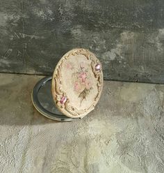 a small round object sitting on top of a metal plate next to a wooden wall