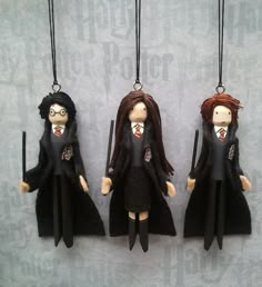 three harry potter doll ornaments hanging from strings