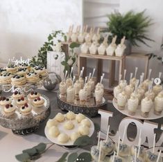 a table topped with lots of desserts and cupcakes