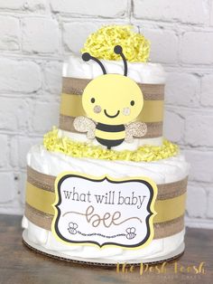 a three tiered cake with a bee on top and what will baby bee written on it