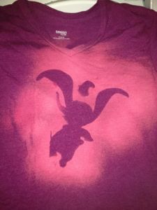 a purple t - shirt with an image of a bird on it