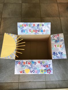 an open box on the floor that says, we're a ray of sunshine to remind you that we are god