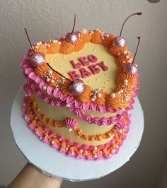 a birthday cake decorated with pink and orange icing