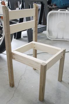 a wooden chair sitting on top of a cement floor