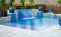 a pool with a waterfall in the middle and blue planters around it for $ 995k