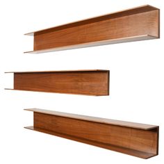 three wooden shelves are shown against a white background