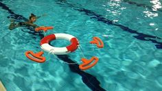 an inflatable life preserver floating on top of a swimming pool next to a man