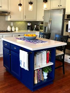 a kitchen island with books on it in front of an oven