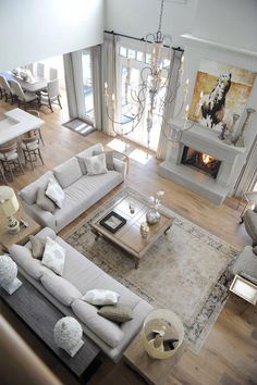 an aerial view of a living room with couches, tables and fireplace in it