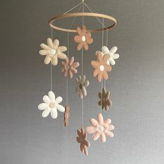 a mobile with flowers hanging from it's sides