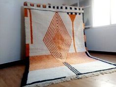 an orange and white rug is on the floor