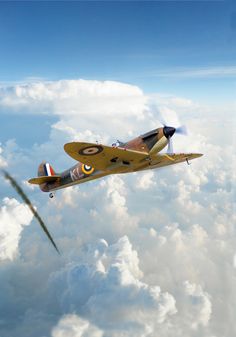 an airplane flying in the sky above clouds