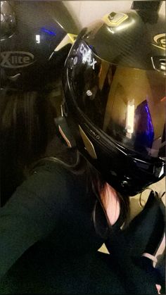 a person wearing a motorcycle helmet and sitting down