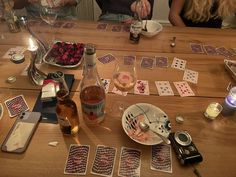 people sitting at a table with cards and wine