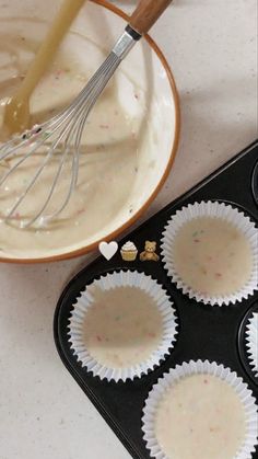 cupcake batter being poured into the muffin tins