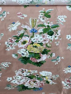 a pink floral wallpaper with white and blue flowers on the bottom half of it