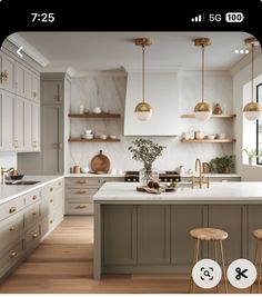 a kitchen with two stools in front of the island