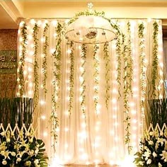 the wedding stage is decorated with white flowers and greenery