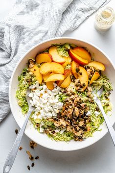 a white bowl filled with fruit and nuts