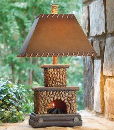 a lamp that is sitting on top of a stone block with a fire in it