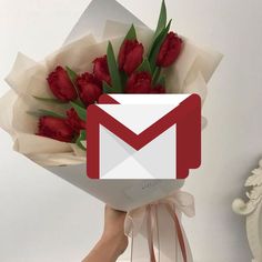 someone holding a bouquet of flowers with an email message on it