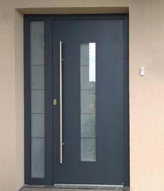 the front door is made of glass and steel