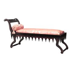 an ornate bench with pink fabric on it's seat and back rests against a white background