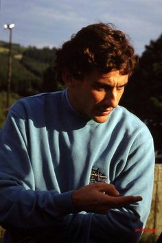 a man in a blue sweater is holding something