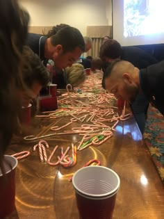 several people gathered around a table covered in candy canes