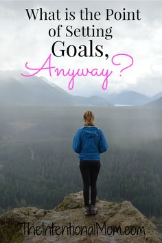 a woman standing on top of a rock with the words what is the point of setting goals?