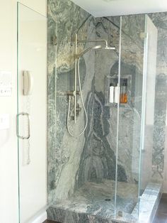 a walk in shower sitting inside of a bathroom