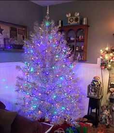 a white christmas tree with multicolored lights