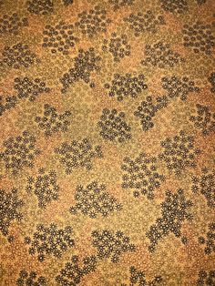 an old carpet with black and gold designs on it