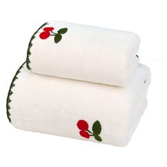 two white towels with cherries on them