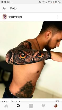 a man with an owl tattoo on his arm is holding up the upper half of his body