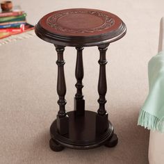 a small wooden table sitting on top of a carpeted floor