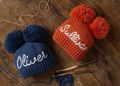 two knitted hats sitting on top of a wooden floor