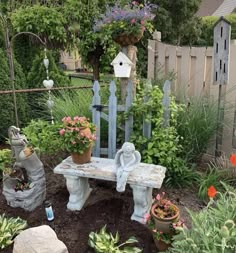 a garden with flowers, plants and a bench made out of old wooden planks