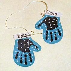 two handprinted blue and black mitts with name tags